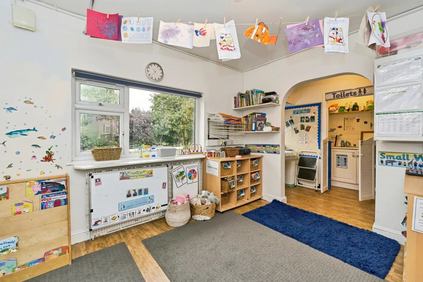 Blue Room at Montys Nursery with play areas and children’s artwork