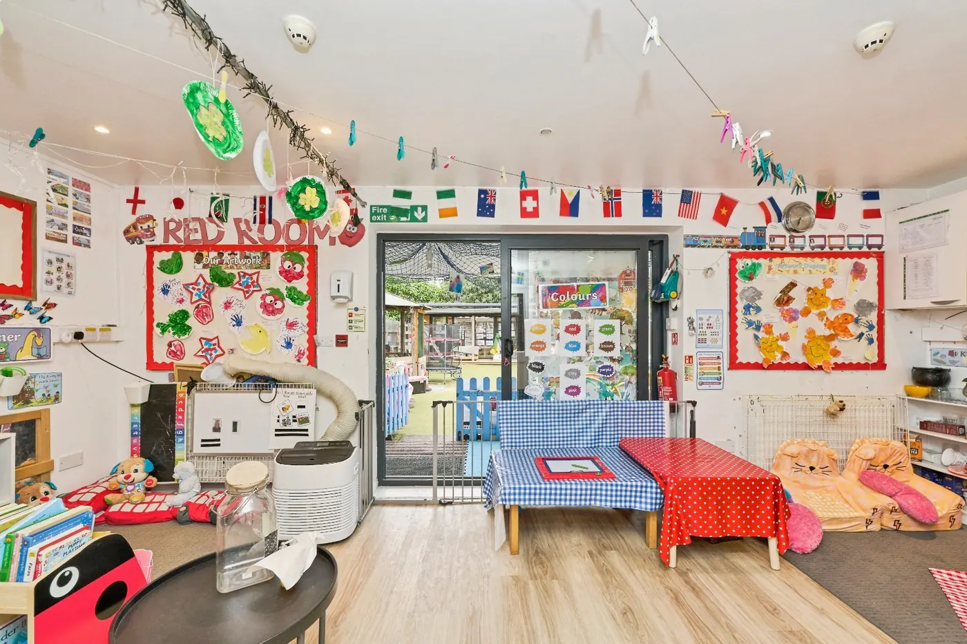 Red Room at Montys Nursery with bifold doors opening to the garden